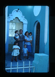 Family outside Iglesia de Cristo by Haven L. Miller