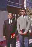 Two men in front of church of Christ building by Haven L. Miller
