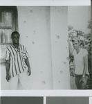 Jim Massey and a Nigerian Man Stand Next to Bullet Holes in a Church Building, Owerri, Nigeria, ca.1967-1969