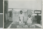Two Children Standing with Packages of Religious Supplies Sent from Churches of Christ in American, Torreon, Mexico, 1946